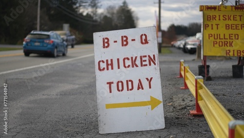 BBQ Chicken sandwich board signs on the side of the road directing hungry customers.