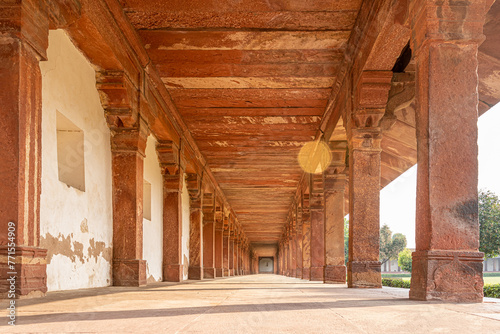 A walkway in the old Indian Taj Mahal complex. The vintage beams narrating the mughal dynasty history in India