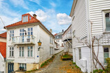 Street with white wooden houses in central Bergen, Norway