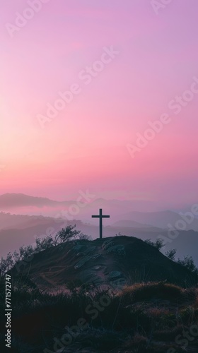 A hilltop Christian cross is bathed in soft light.