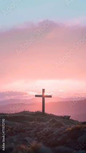 The soft light gently illuminates a Christian cross on the hill.