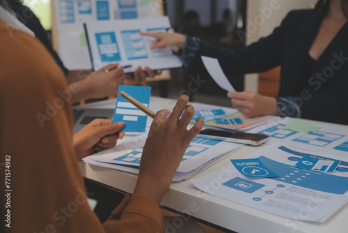 Close up ux developer and ui designer use augmented reality brainstorming about mobile app interface wireframe design on desk at modern office.Creative digital development agency