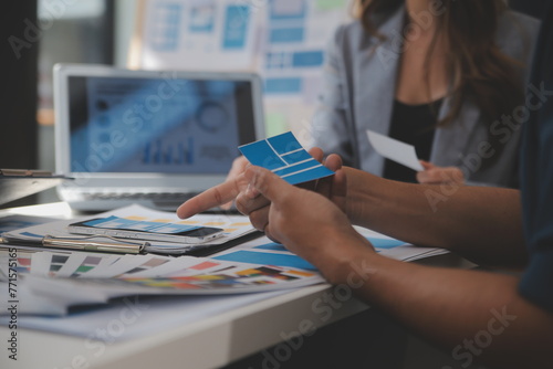 Close up ux developer and ui designer use augmented reality brainstorming about mobile app interface wireframe design on desk at modern office.Creative digital development agency