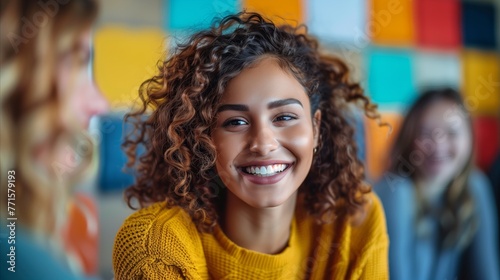 Smiling Young Woman in Yellow Sweater Indoors © OKAN