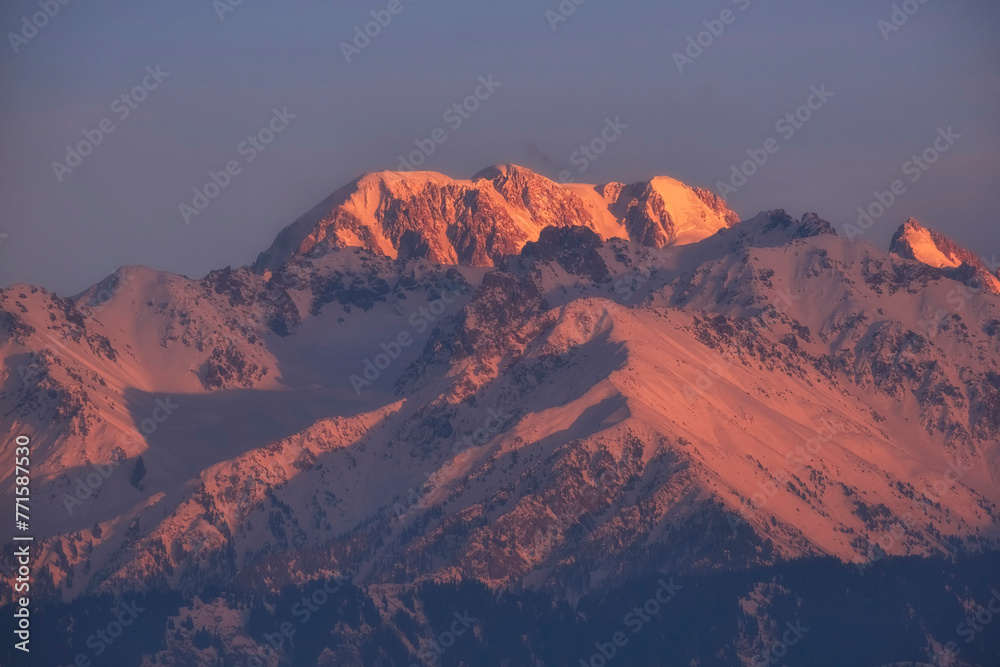 mountain peak Talgar the highest mountain in the Trans-Ili Alatau at sunset, Almaty city Kazakhstan