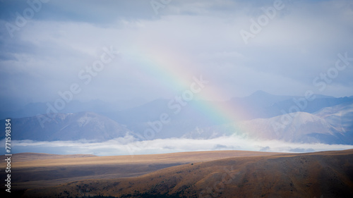 Rainbow arching over alpine landscape just after the storm, New Zealand