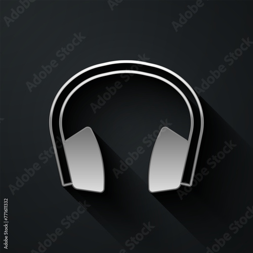 Silver Noise canceling headphones icon isolated on black background. Headphones for ear protection from noise. Long shadow style. Vector