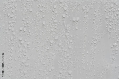 Water drops on white background texture. backdrop glass covered with drops of water. grey bubbles. condensate
