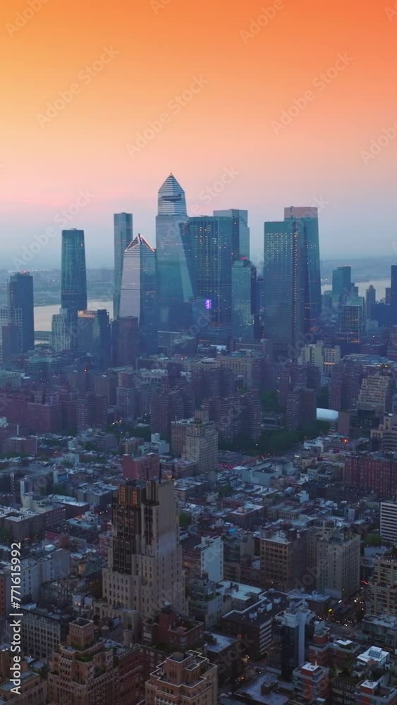 Rising over densely built cityscape of New York. Impressive architecture of excellent metropolis at the backdrop of pink sky. Vertical video Rising over densely built cityscape of New York. Impressive architecture of excellent metropolis at the backdrop of pink sky. Vertical video