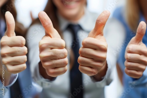 Group of business people giving thumbs up in sign of approvement photo