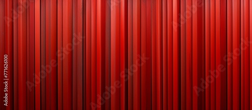 A close up of a stage curtain in shades of carmine, peach, and coquelicot. The pattern of the fabric forms a symmetrical rectangle with hints of electric blue and magenta