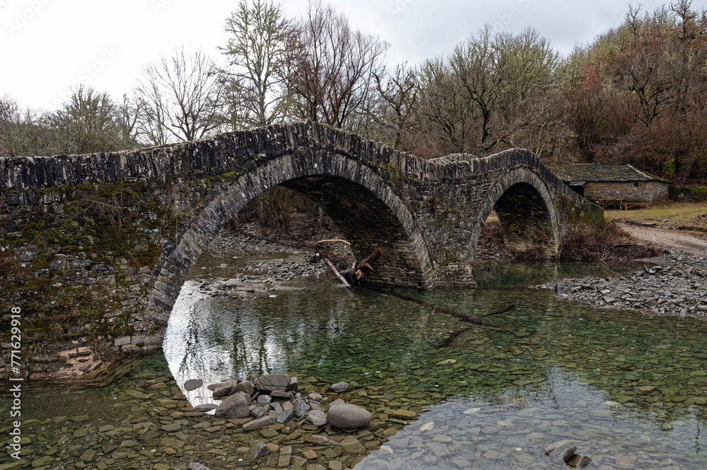 View of the traditional stone Mylos Bridge near the village of Kipi in Zagori of Epirus, Greece.