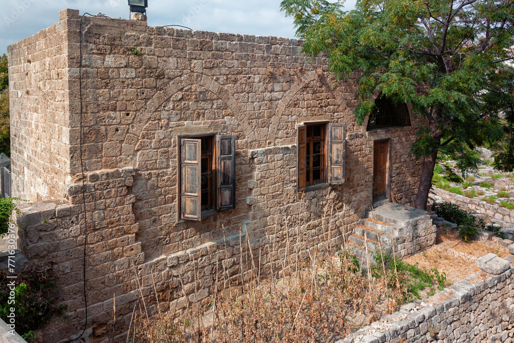 View of the old traditional Lebanese stone house in Byblos, Lebanon. The house is part of the ancient archaeological complex located next to it.