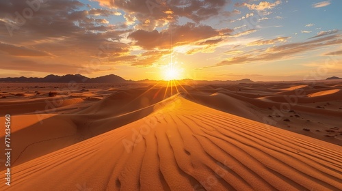 A desert landscape with a sun setting in the background. The sky is filled with clouds, creating a moody atmosphere