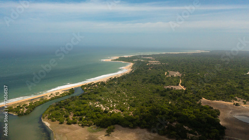 Ocean with a beach in the national park among the jungle. © Alex Traveler