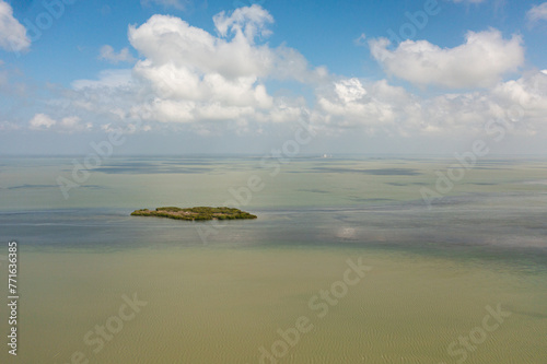 Aerial view of Tropical island and blue sea against the sky and clouds.