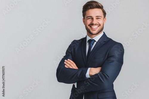 Professional Young Businessman Smiling in Blue Suit with Arms Crossed on White Background