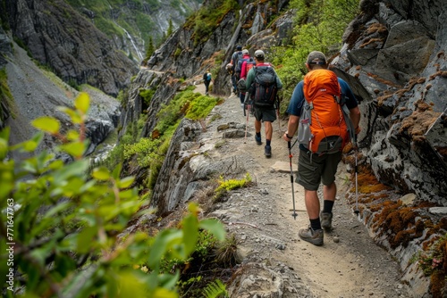 A group of hikers ascending a winding mountain trail, showcasing physical exertion and determination