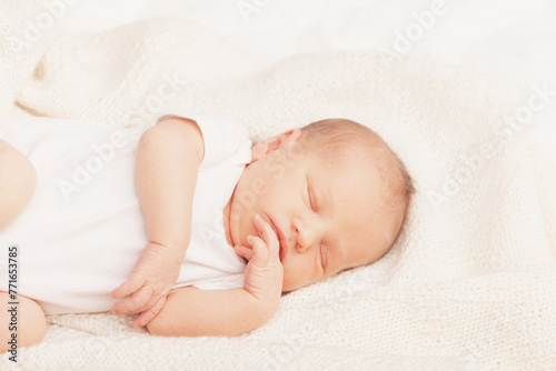 Newborn Baby Asleep on Cream Blanket