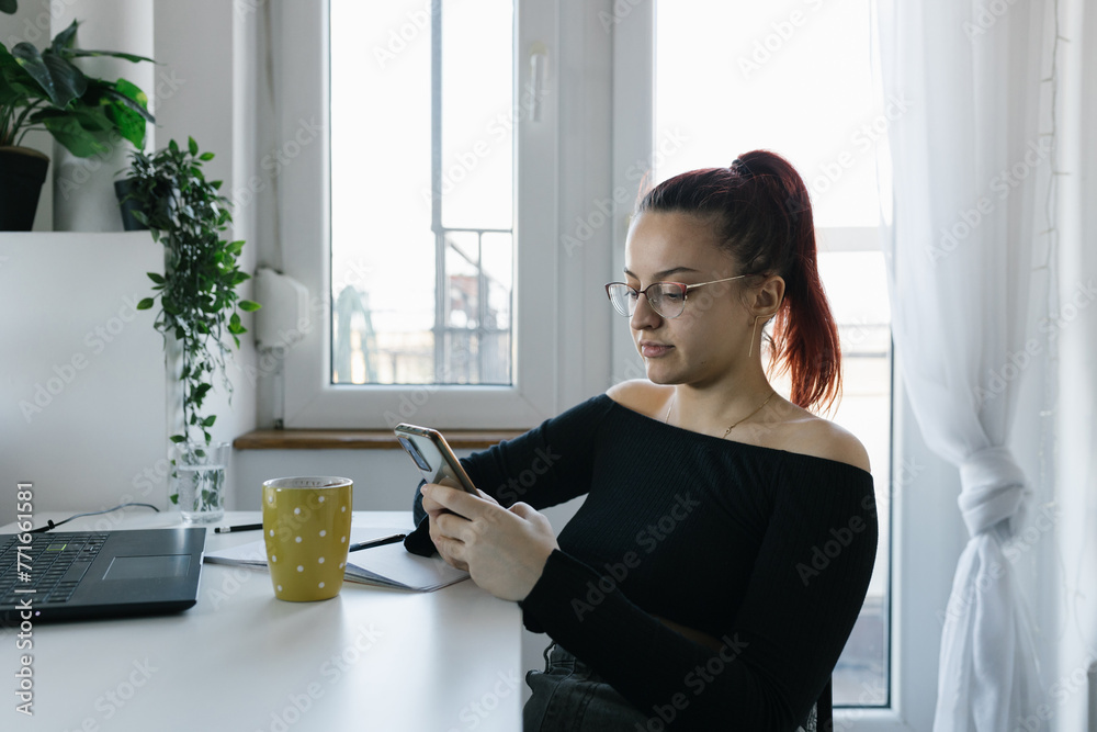 Young woman using smartphone at home Young woman using smartphone at home