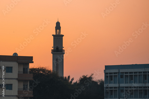A minaret in Umm Al Quwain, United Arab Emirates, at sunset. photo