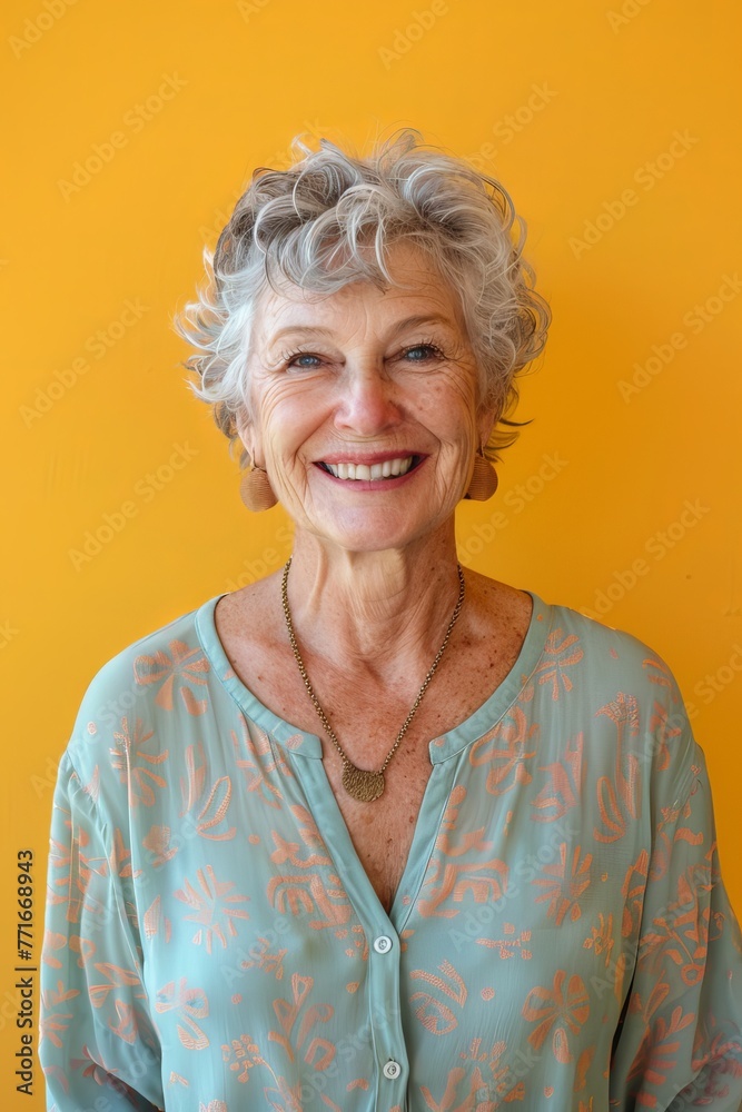 medium shot of a caucasian older woman standing and smiling, yellow background medium shot of a caucasian older woman standing and smiling, yellow background