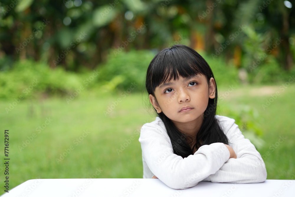 The sullen expression of an Asian girl with a flat face The sullen expression of an Asian girl with a flat face