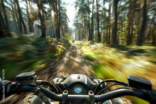 A motion-blurred image of a quad bike speeding through a forest photo