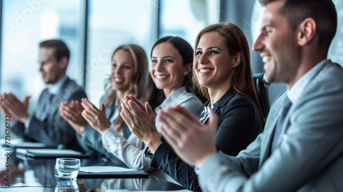 Group of business people clapping hands in a meeting at a corporate office. Successful team collaboration and agreement concept.