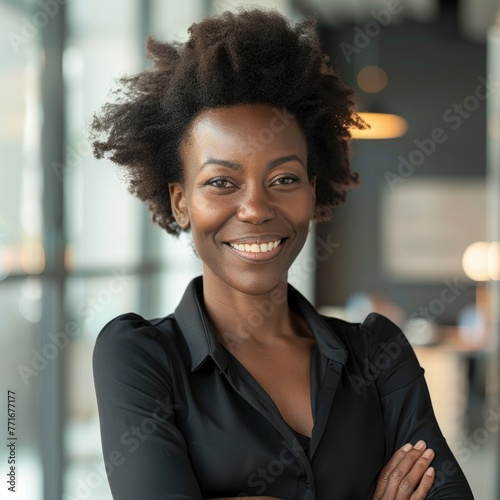 Smiling African American businesswoman 40-50 years old, active business woman against the background of her office