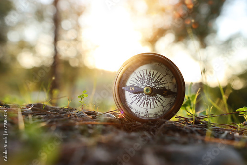 compass on forest ground. concept of finding direction and leadership © tomertu