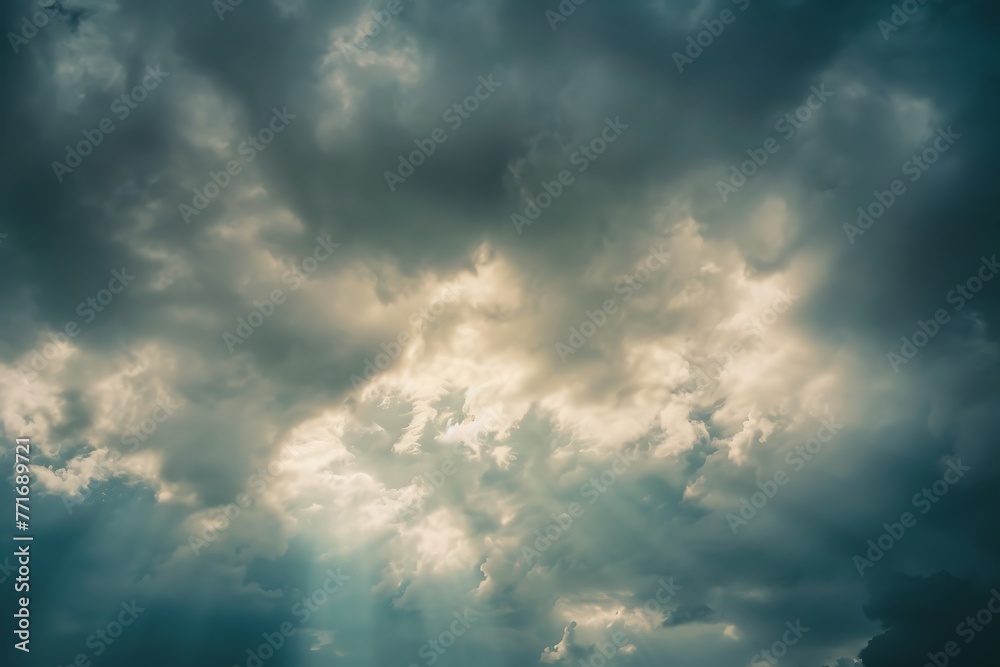 : A cloudy sky with a brief clearing, where the sun is shining through before the clouds gather again