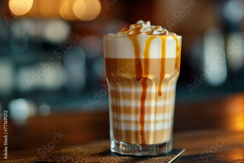 Caf   Latte in a Tall Glass - Perfectly prepared latte with a smooth foam layer  decorated with a caramel pattern