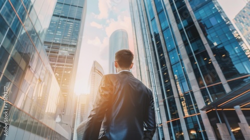 Businessman in Suit Standing in Front of Tall Buildings