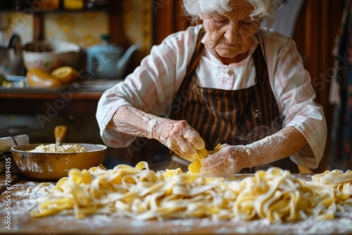 Nonna impegnata a preparare con amore la sua pasta fatta in casa photo