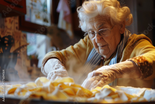 Nonna impegnata a preparare con amore la sua pasta fatta in casa photo