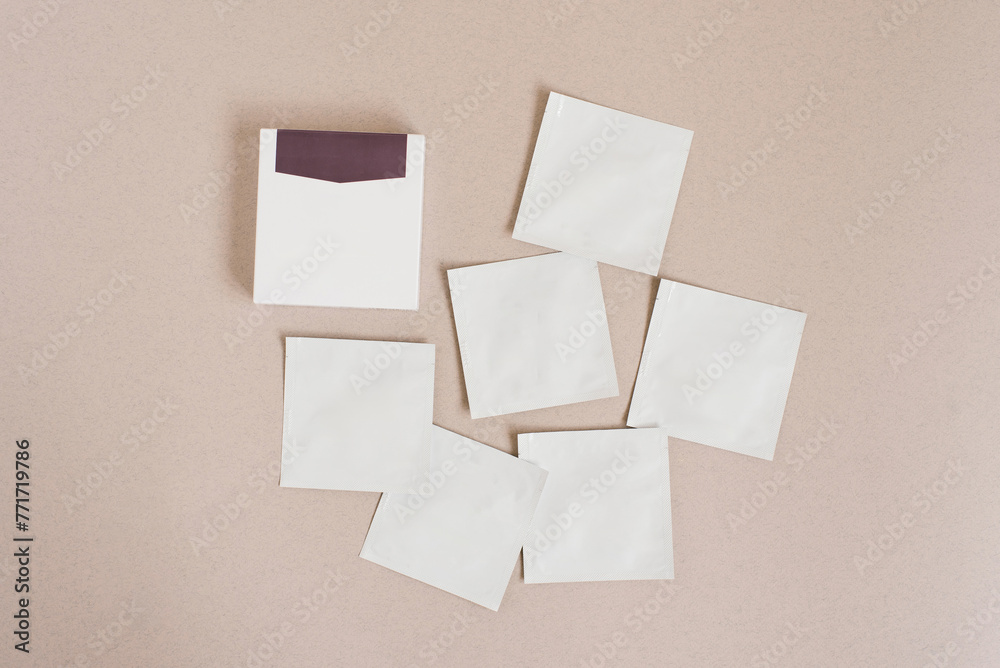 Disposable bags of cosmetics lie on a beige background Disposable bags of cosmetics lie on a beige background