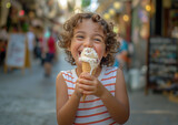 Little boy with curly hair eating ice cream in a waffle cone