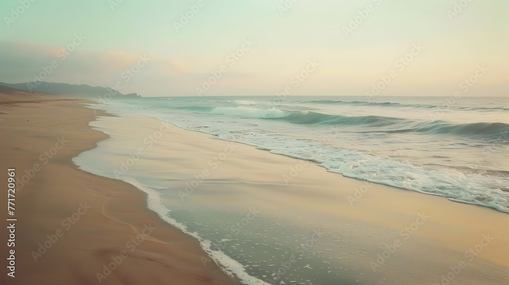 A peaceful sandy beach with gentle waves lapping at the shore under a soft, pastel twilight sky evoking calmness and reflection