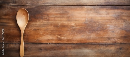 A wooden spoon rests on a rectangle of hardwood flooring, showcasing the natural beauty of the wood grain with its varnish finish