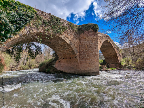 Mediaeval bridge bridge over Iregua river, Viguera village, Cameros, La Rioja, Spain photo