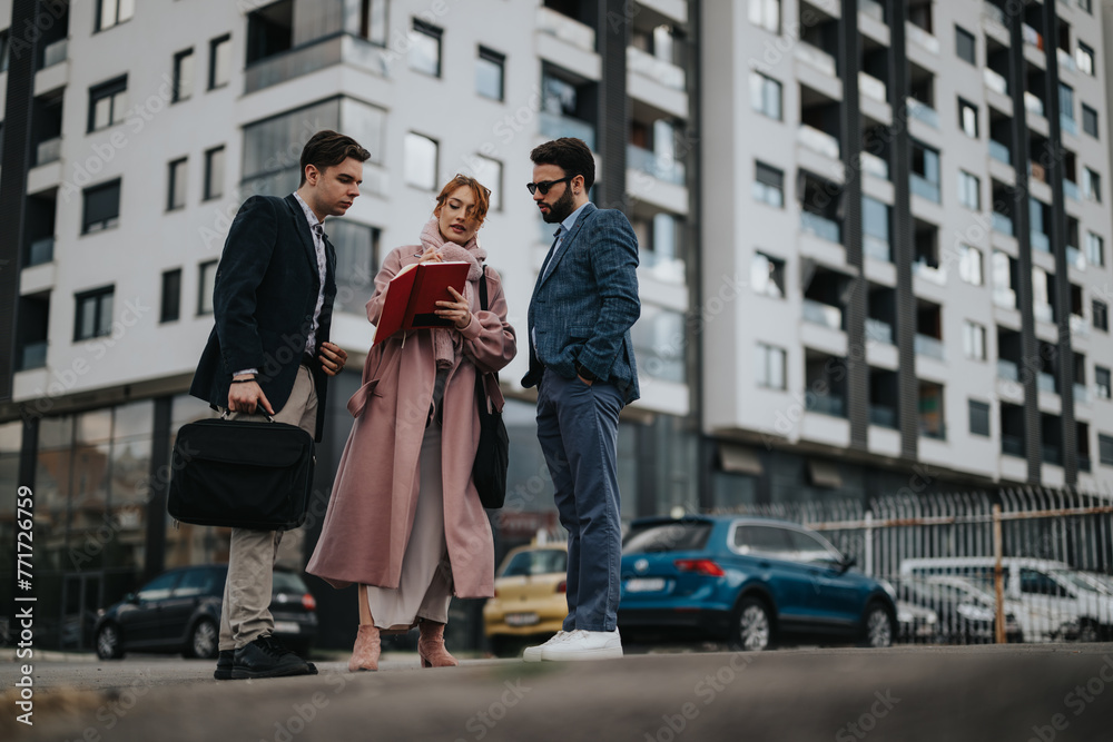 A team of young business coworkers engaging in a strategic outdoor meeting against an urban city backdrop.