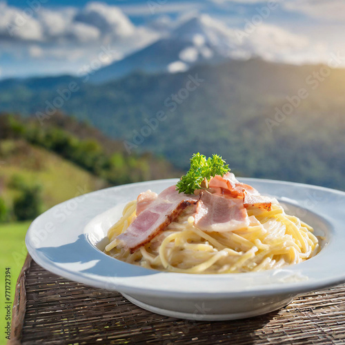 A plate of spaghetti with bacon on table with mountain in backgraund photo illustration photo