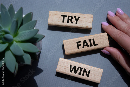 Try Fail Win symbol. Concept words Try Fail Win on wooden blocks. Beautiful grey background with succulent plant. Businessman hand. Business and Try Fail Win concept. Copy space.