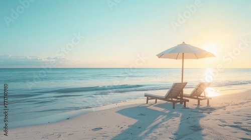 Two Sun Loungers Sheltered by an Umbrella, Gazing upon the Peaceful Seascape on White Sand during sun set © Image