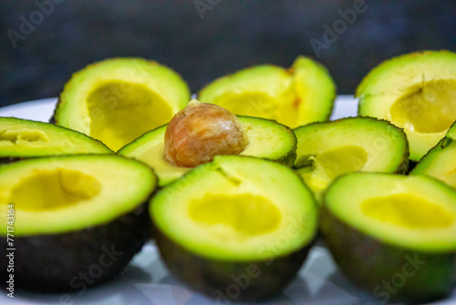 Ripe avocados cut in half in selective focus