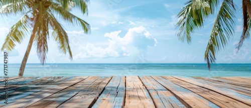Wooden Deck with Tranquil Blue Sea, Sky Background, and Palm Tree Silhouette © Image