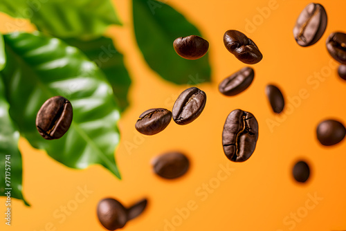 Coffee beans in mid-air with green leaves on an orange background. Floating coffee beans with greenery, warm orange surface. Coffee beans and leaves levitating on a vibrant orange background photo