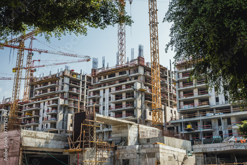 Building cranes on construction site in Tel Aviv city, Israel photo