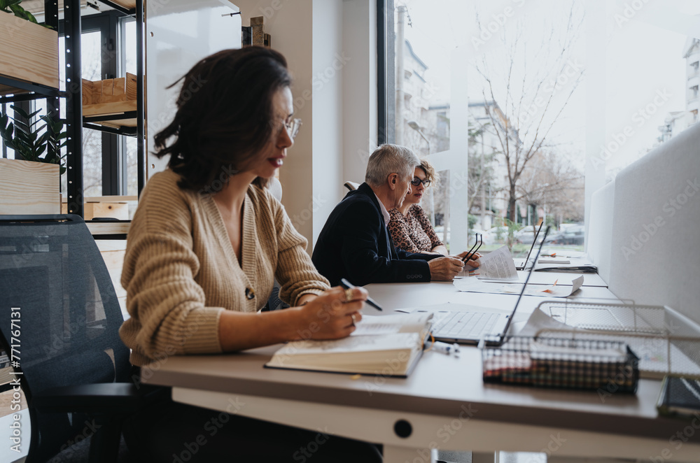 Female coworker working in an office, discussing business strategies and finding innovative solutions. She works on a project, using technology for success. Female coworker working in an office, discussing business strategies and finding innovative solutions. She works on a project, using technology for success.